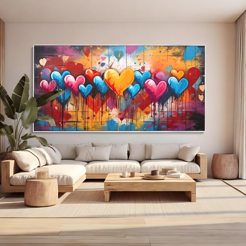 Tablou canvas cu tablou canvas cu inimi colorate, in rama de aluminiu argintiu, pe perete intr-un living